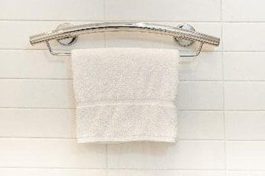 A towel hanging on the wall of a bathroom.