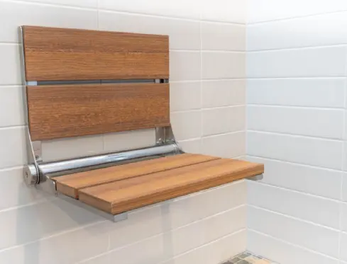 A wooden bench in the corner of a bathroom.